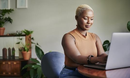 Woman on laptop in her home office.